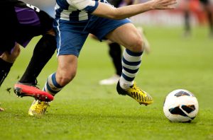 football- legs of two soccer players vie on a match